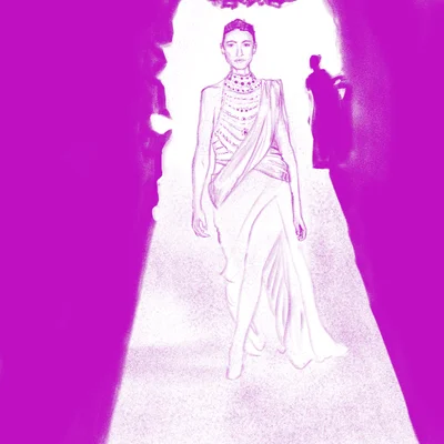 a woman in an ornate dress walks down a lit up catwalk, while figures in the background look on